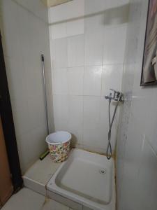 a small bathroom with a bucket in the corner at zone 44 Massira 3 in Marrakech