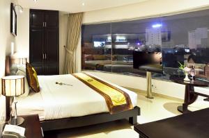 A bed or beds in a room at D&C Hotel