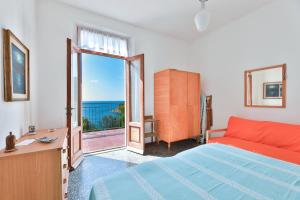 a bedroom with a bed and a view of the ocean at La Terrazza sul Forno - Goelba in Portoferraio