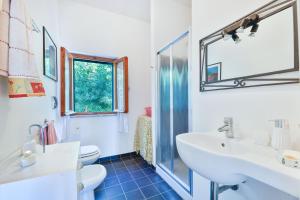 a bathroom with a sink and a toilet and a mirror at La Terrazza sul Forno - Goelba in Portoferraio +15 photos