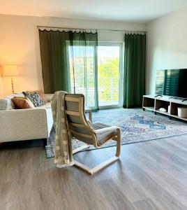 a bedroom with a chair and a bed and a window at NEW Modern Condo FREE Parking & High Speed Wifi in Hollywood