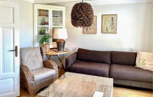 a living room with a couch and a chair at Vesthassel-Nesheim in Borhaug +31 photos