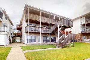 an apartment building with a spiral staircase in a yard at River on the Pointe in Ventress