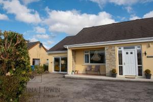 a detached house with a driveway in front of it at The Snug in Donegal