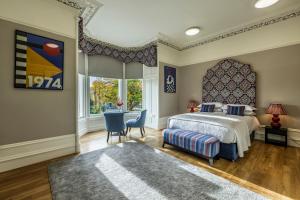 a bedroom with a bed and a large window at 8QR Rooms in Aberdeen