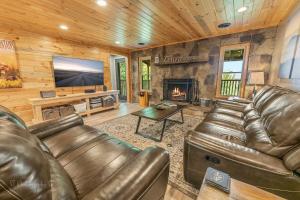 a living room with leather furniture and a fireplace at Dolly's Lodge # 3 condo in Sevierville