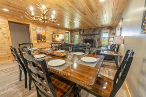 a dining room with a wooden table and chairs at Dolly's Lodge # 3 condo in Sevierville +34 photos
