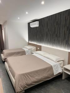 Ένα ή περισσότερα κρεβάτια σε δωμάτιο στο Hotel Blanc