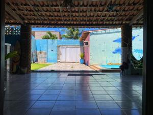an empty room with a blue wall and a tile floor at República Francês in Marechal Deodoro