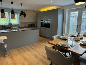 a kitchen and dining room with a table and chairs at Bounty On The Lakes in Bowness-on-Windermere