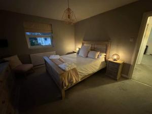 a bedroom with a large bed with two towels on it at Bounty On The Lakes in Bowness-on-Windermere