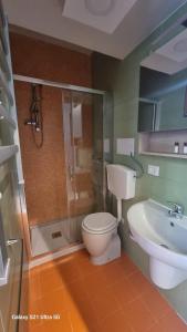 a bathroom with a shower and a toilet and a sink at Tisara home in Portici