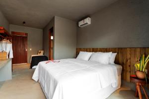 a bedroom with a large white bed in a room at Pousada Oribá Chalé Boutique Milagres - AL in São Miguel dos Milagres +43 photos