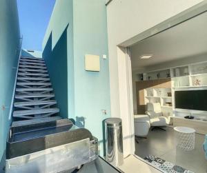 a room with a staircase and a living room at Appartement Rooftop 360 - JACUZZI - Parking - Clim - wifi in Mauguio