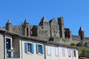a castle with turrets on top of a building at Carcas Hôtes Guest House in Carcassonne
