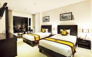 A bed or beds in a room at D&C Hotel