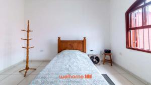 Ένα ή περισσότερα κρεβάτια σε δωμάτιο στο Espaço incrível à 7 minutos a pé da praia em Itanhaém