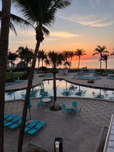 a view of a pool with palm trees and a sunset at Miami Hollywood Great 2 Bedroom with Garden View 001-22bmar in Hollywood