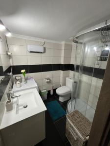 a bathroom with a sink and a shower and a toilet at Seagull center kavala in Kavala +26 photos
