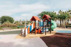 a playground in a park with a slide at RESORT BEACH VALENCIA in Valencia