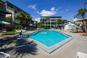 a swimming pool in a resort with people in it at Nautical Watch A2 in Panama City Beach