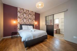a bedroom with a large bed and a wall at Casa Soma in Saint-Marcel