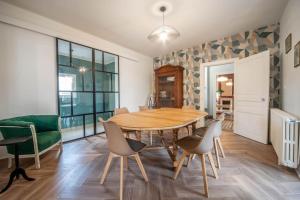 a dining room with a wooden table and chairs at Casa Soma in Saint-Marcel