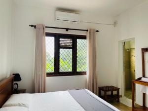 a bedroom with a bed and a stained glass window at Blue Ridge Homestay in Kandy