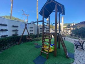 a playground with a ladder and a slide at Apartamento pé na areia in Ubatuba