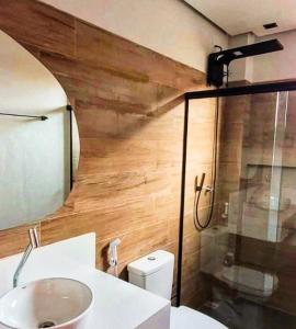 a bathroom with a sink and a shower and a toilet at Vila Tanrral in Lençóis +28 photos