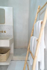 a towel ladder in a bathroom with a shower at Riad COPAH in Marrakech