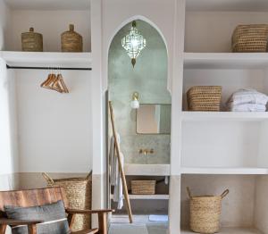 a hallway with a stairway with chairs and a mirror at Riad COPAH in Marrakech +15 photos