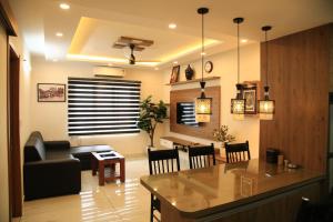 a living room with a couch and a table at The Golden Grotto in Trivandrum