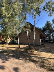 a house with trees in front of it at Domki pod Aniołem in Huta