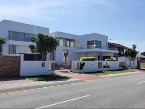 a white house on the side of a street at Martha's Guesthouse in Gqeberha