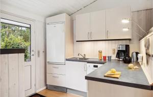 a kitchen with white cabinets and a counter top at Stunning Home In Fårvang With Wifi in Fårvang