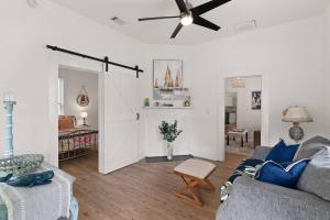 a living room with a couch and a ceiling fan at Odie's Oasis on Union in Brunswick