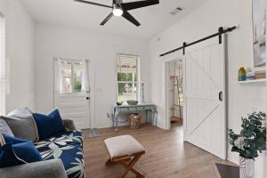 a living room with a couch and a ceiling fan at Odie's Oasis on Union in Brunswick +24 photos