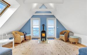 a living room with a fireplace in the attic at 2 Bedroom Beautiful Home In Tranekær in Tranekær +18 photos