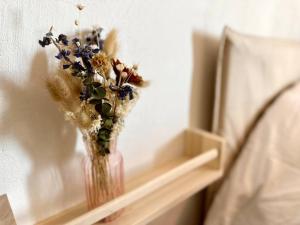 a vase filled with flowers sitting on a shelf at Exceptionnel Appartement avec Cinema - Cap d'Agde in Agde