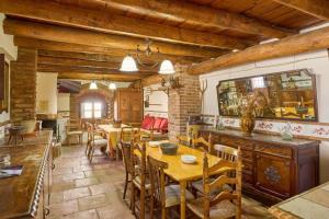 a dining room with wooden tables and chairs at Casa Rural con encanto El Coronel, Los Pánchez, Fuente Obejuna in Los Pánchez