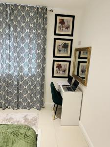 a bedroom with a desk with a laptop on it at Home Sweet Home Studio in Foleshill +4 photos