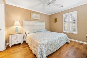 a bedroom with a bed and a ceiling fan at 53B Blue Wedge at True Blue condo by Peace Vacations in Pawleys Island +18 photos