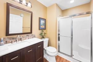 a bathroom with a shower and a toilet and a sink at 53B Blue Wedge at True Blue condo by Peace Vacations in Pawleys Island