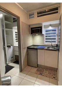a small kitchen with a sink and a counter top at Appt 2 pièces MERCURE 3 étoiles Case Pilote La Capresse in Case-Pilote