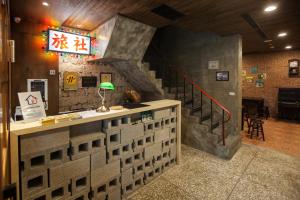 a restaurant with a counter and a stair case at Jian Shan Hotel in Taipei