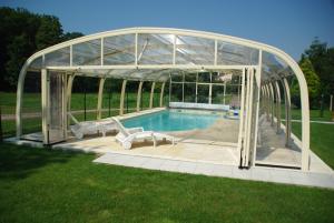 szklany pawilon z basenem na dziedzińcu w obiekcie La Grimodière w mieście Ranville