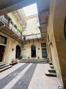 an empty courtyard of an old building with stairs at Palazzo Duomo in Verona