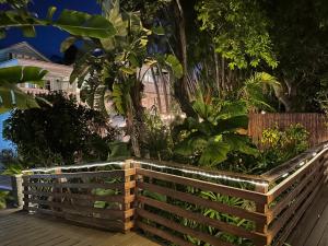 a wooden fence in front of a garden at Douglas House in Key West +197 photos
