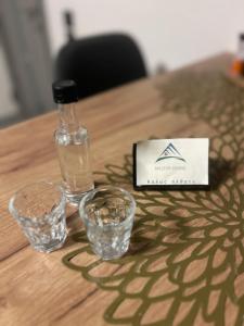 a bottle of water and two glasses on a table at Hilltop house in Ioannina +13 photos